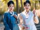 Two young women dressed in traditional Korean clothing posing for a picture.